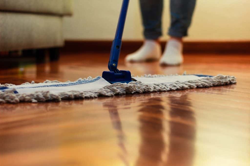 Unrecognizable woman cleaning the hardwood floor